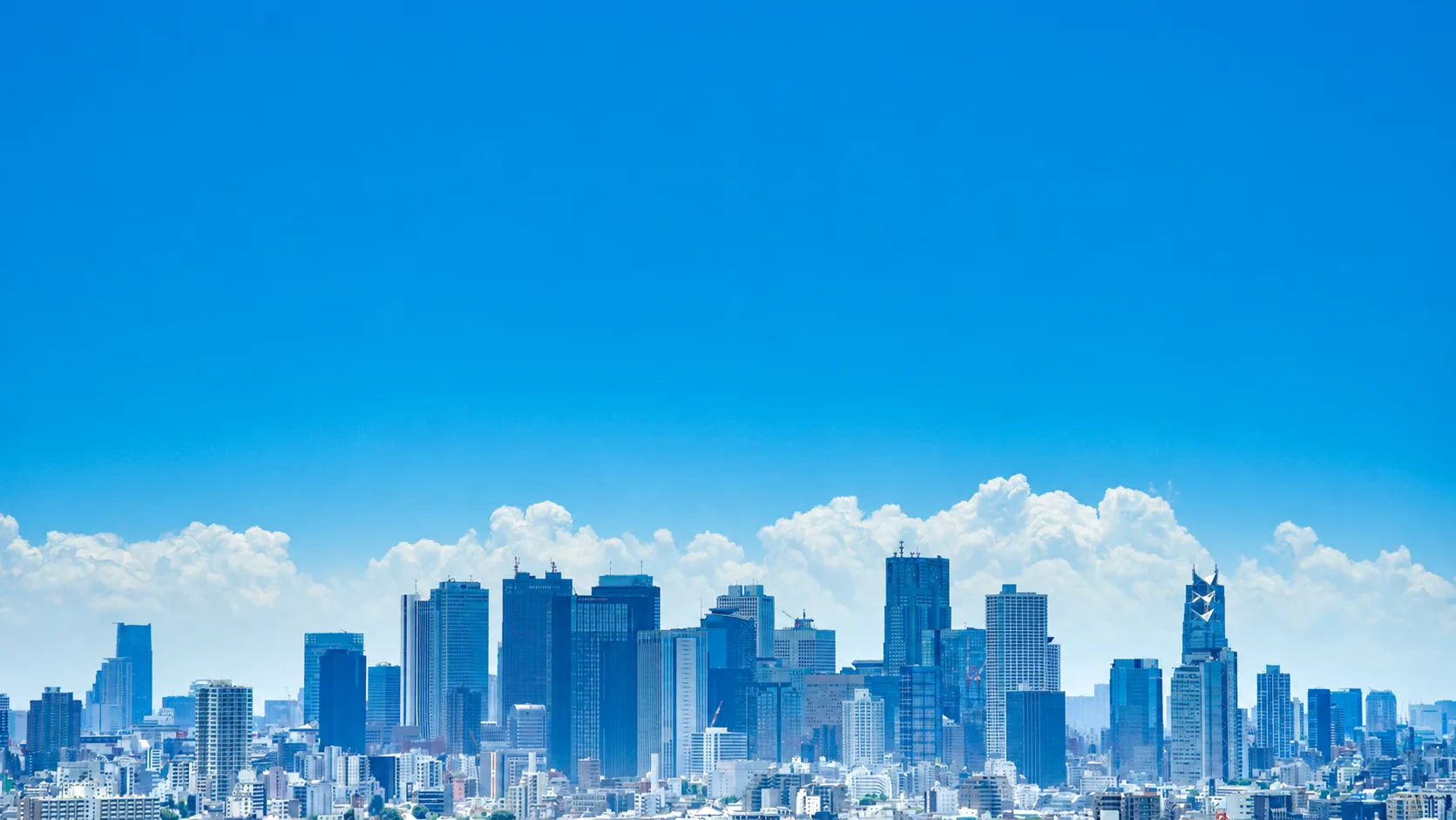 Blue sky over a city skyline